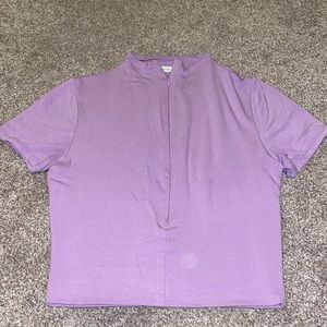 Purple cropped top has a zipper on the front